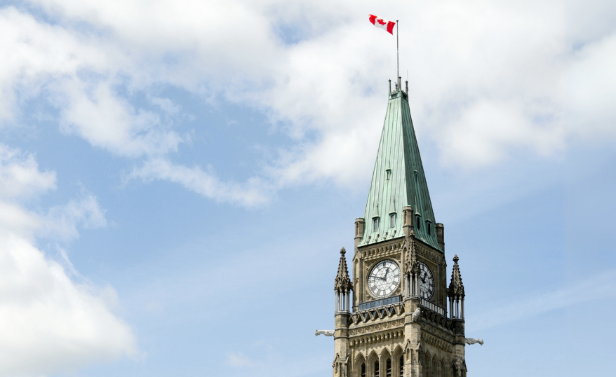 canadian parliament peace tower with blue skies behind it